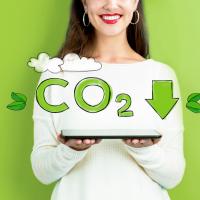 woman holding tablet, awareness about reducing CO2