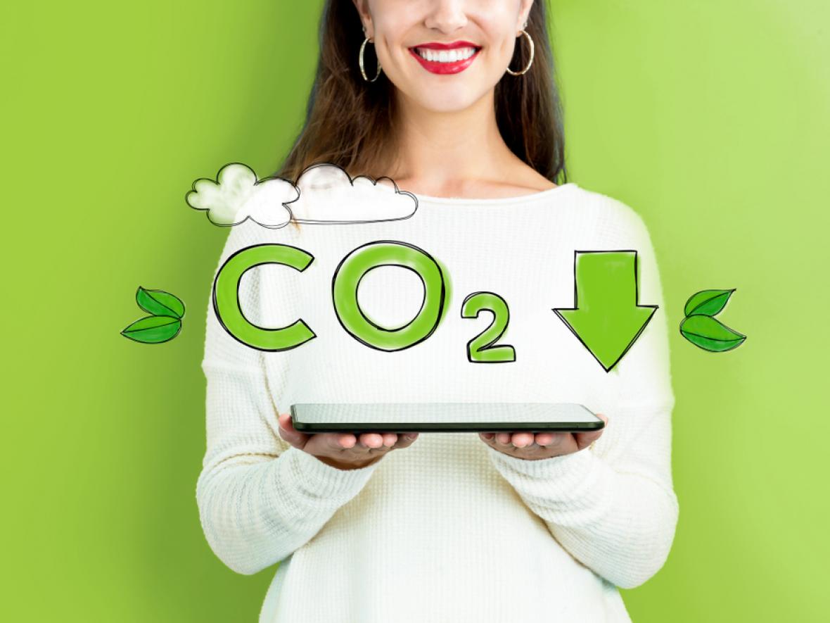 woman holding tablet, awareness about reducing CO2