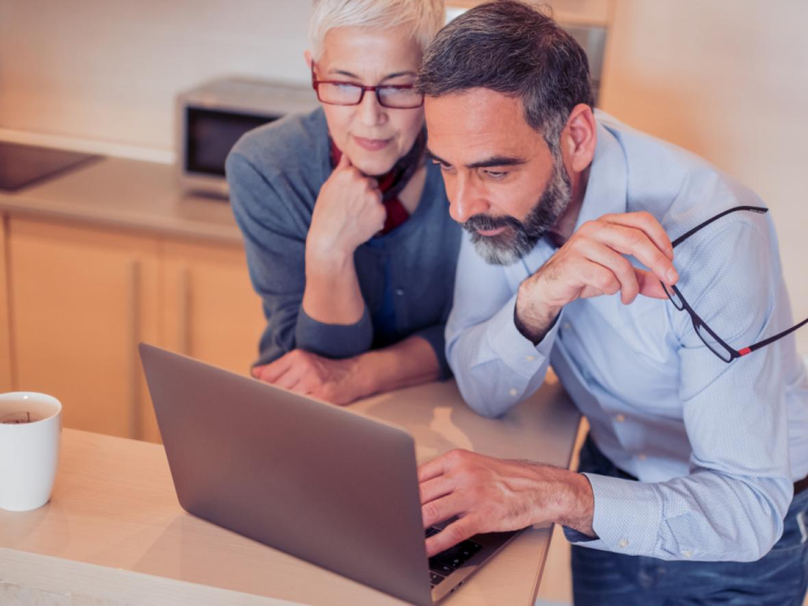 couple looking at a computer couple looking at a computer