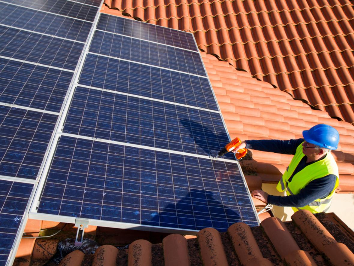 solar panels being installed on a roof solar panels being installed on a roof
