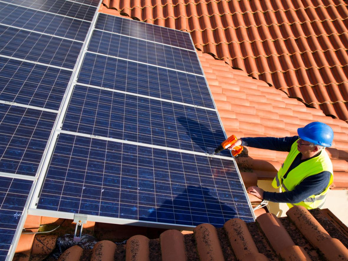 solar panels being installed on a roof