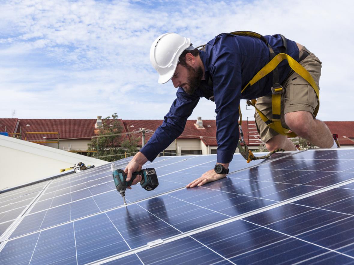 solar panels being installed on a roof