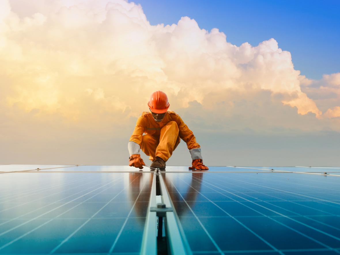 Technician installing solar on roof