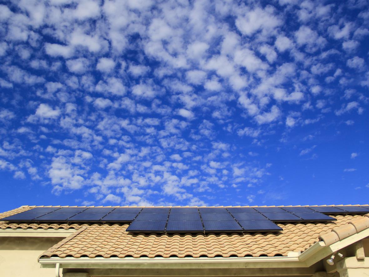 roof with solar panels on it showing big sky beyond