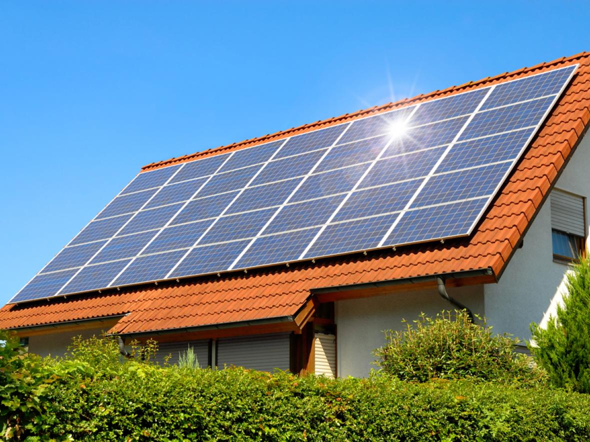 Black solar panels on a red roof