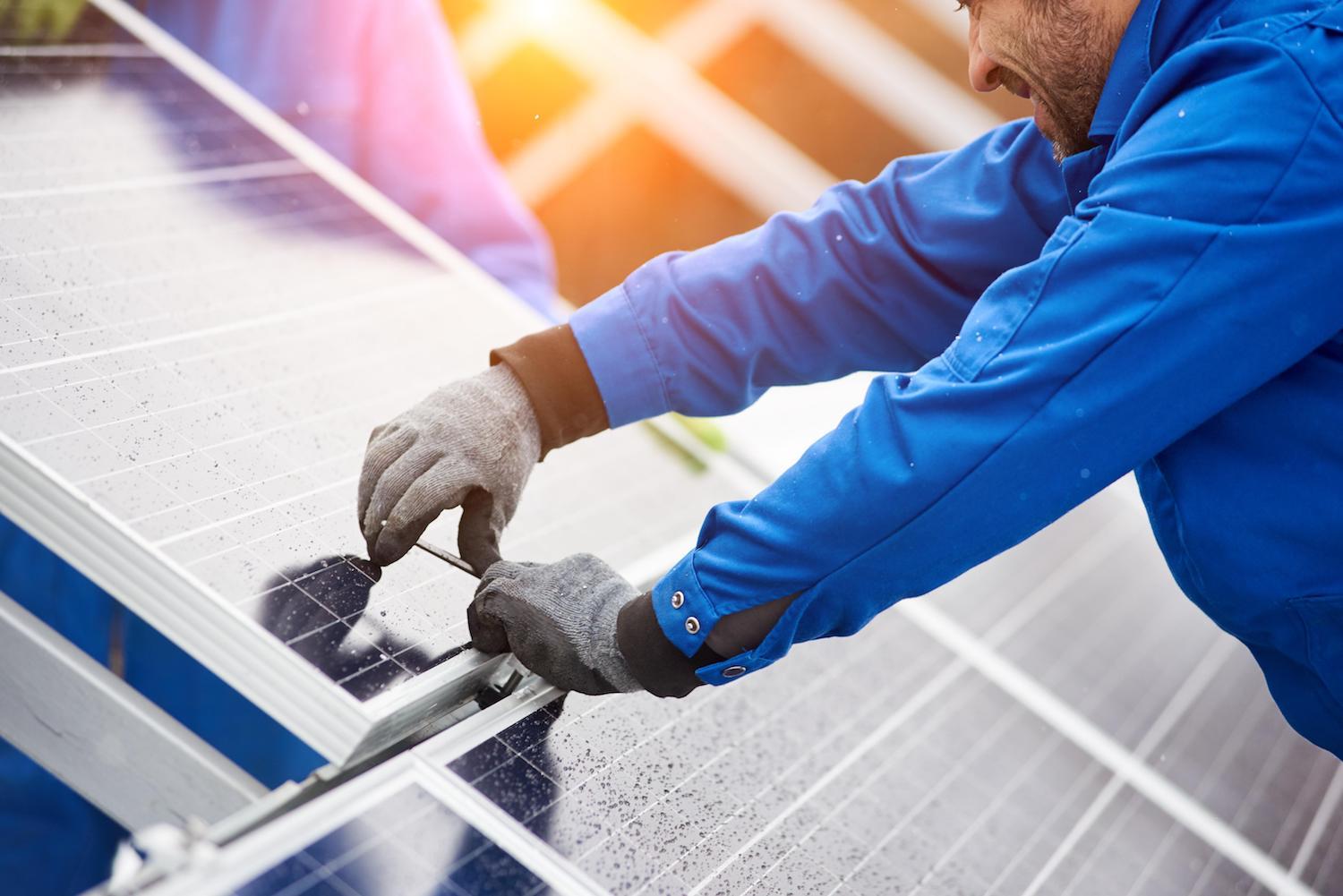 tech installing solar panel